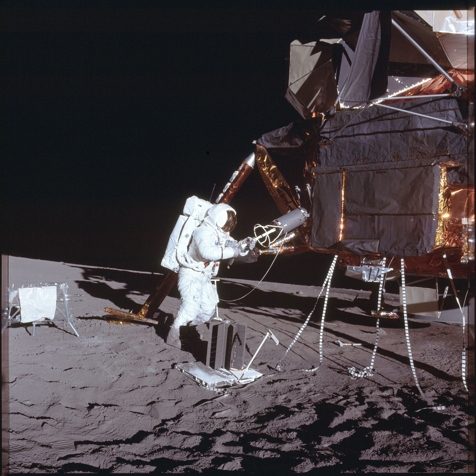 A photo of astronaut Beam removing hot fuel capsule