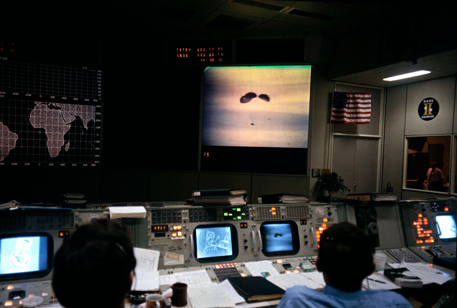 A photo of two flight controllers at Mission Control Center