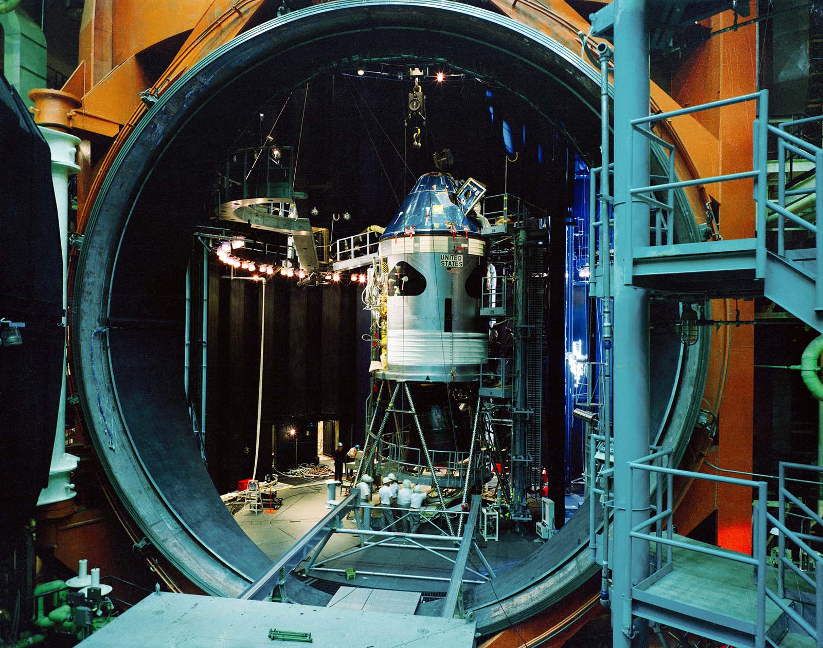 A photo of the command and service modules in a huge test chamber