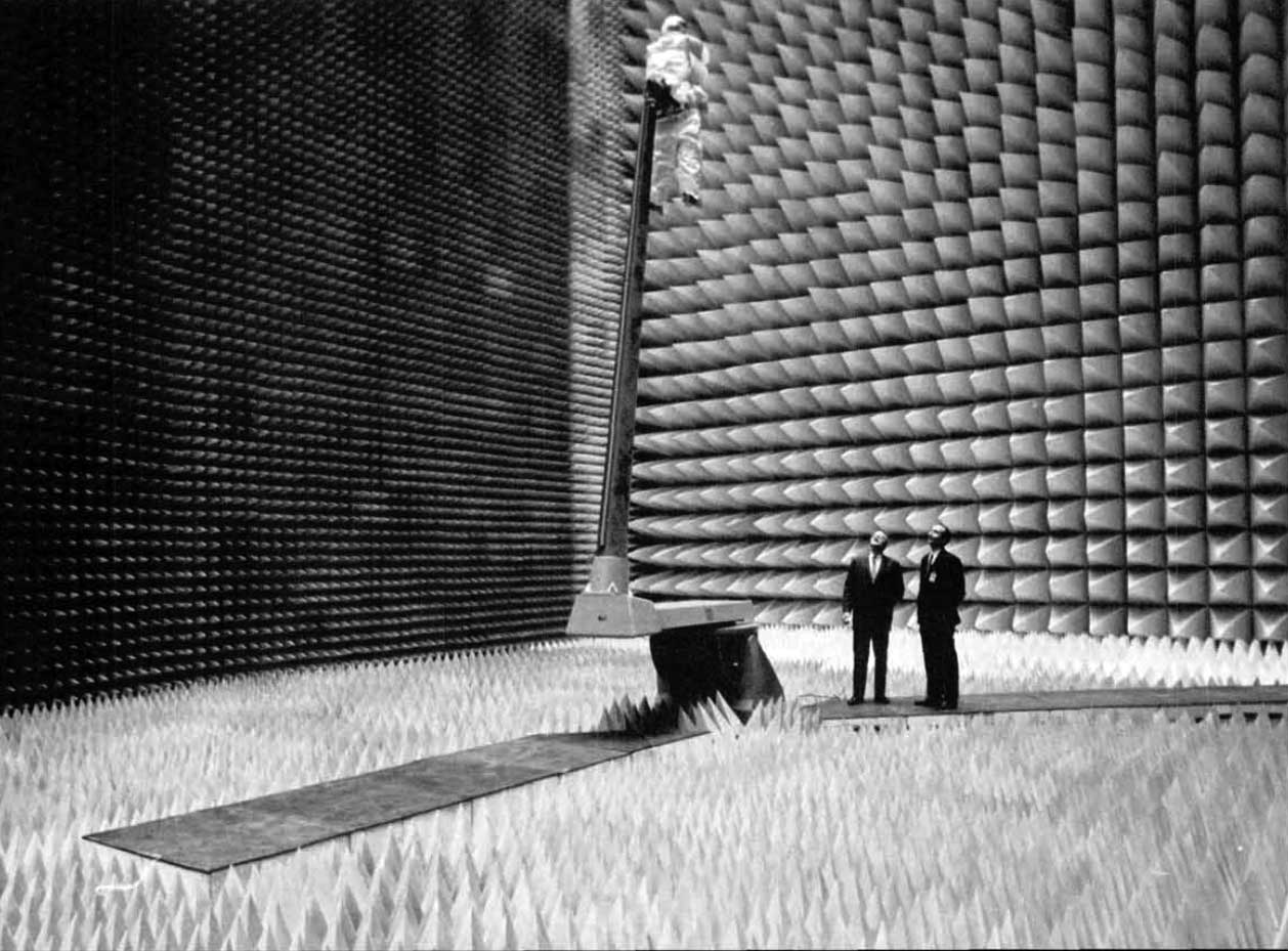 A photo of two NASA engineers in an anechoic test chamber