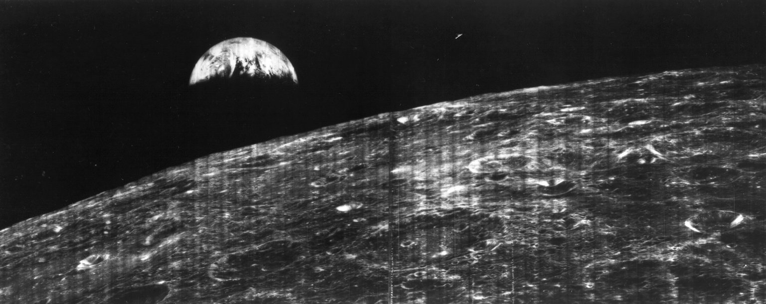 A photo of the Earth rise over the eastern rim of the Moon