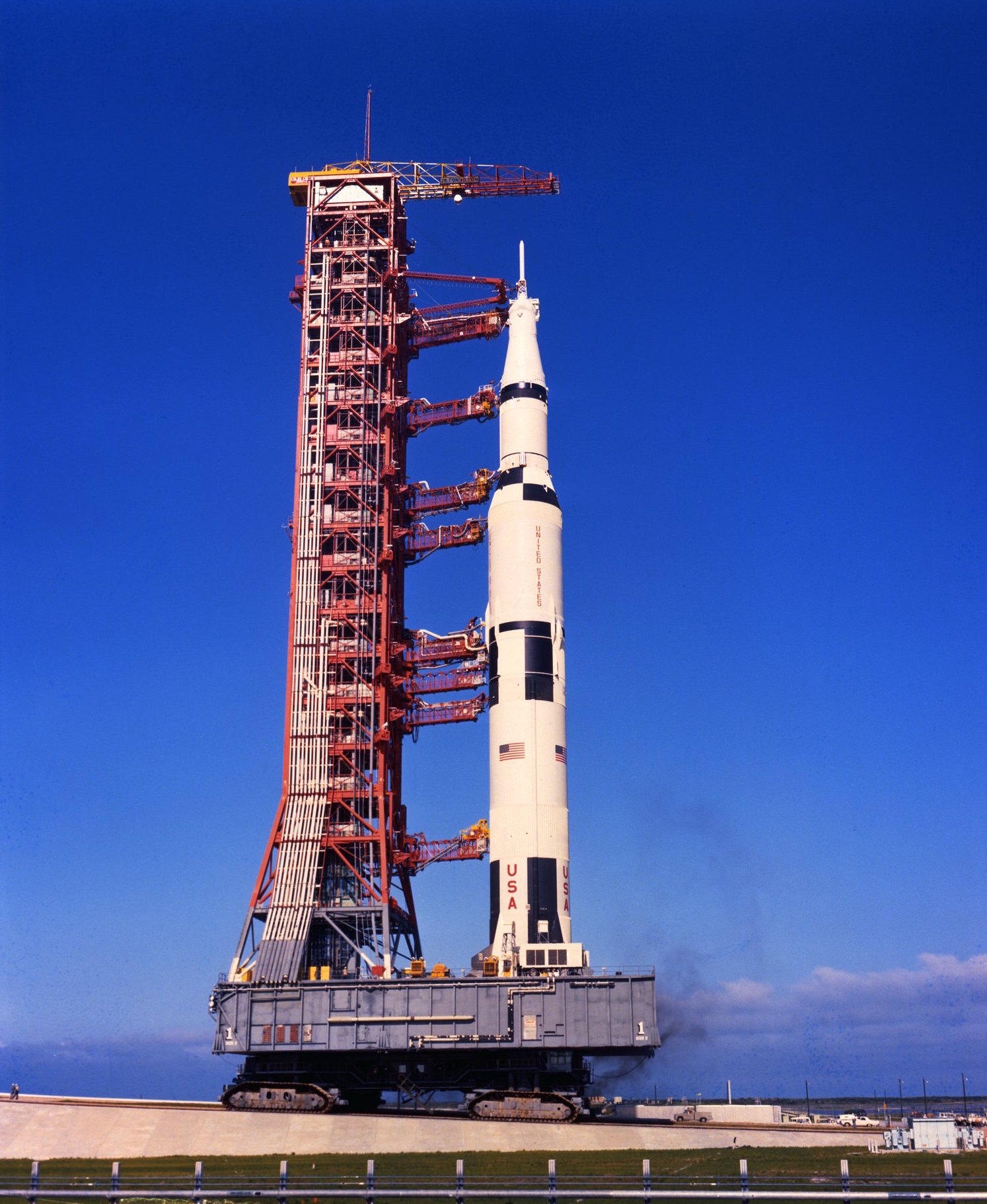 A photo of a crawler carrying a space vehicle and its Mobile Launcher