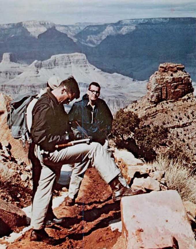 A photo of astronauts and their instructor taking notes