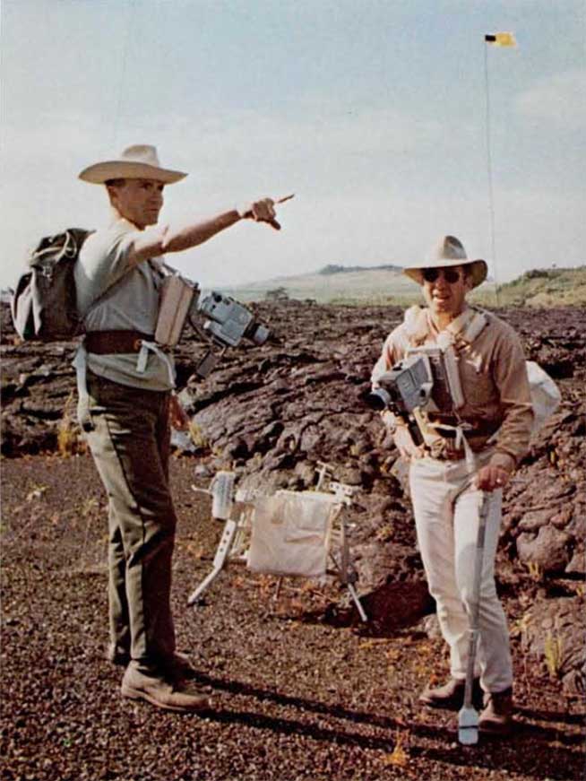 A photo of Apollo 13 astronauts,Haise and Lovell observing lava flow