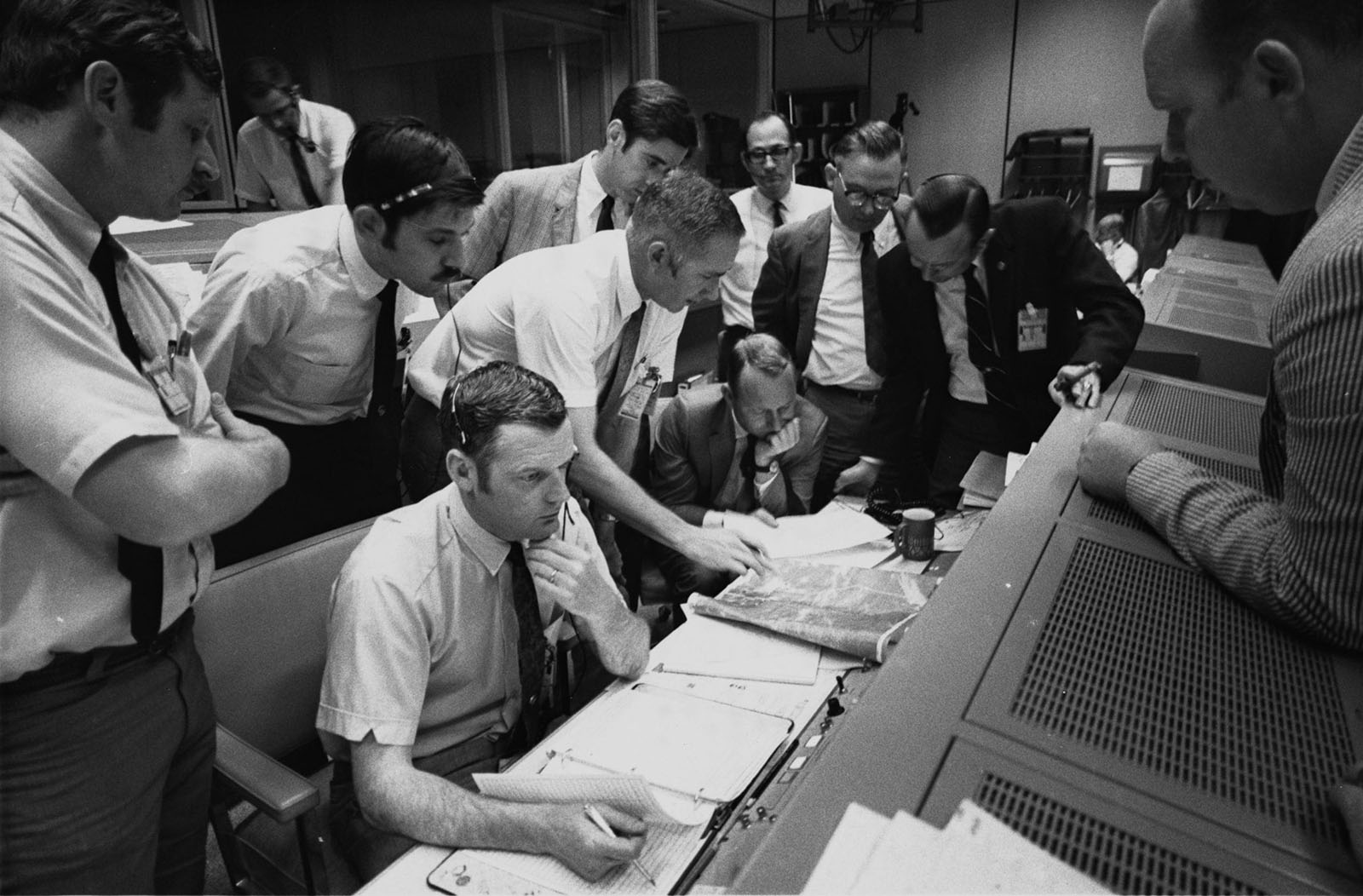 A photo of Mission Control directors in a discussion