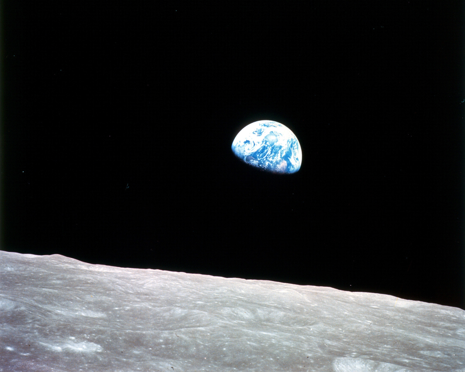 A photo of the Earth rising seen from the far side of the Moon