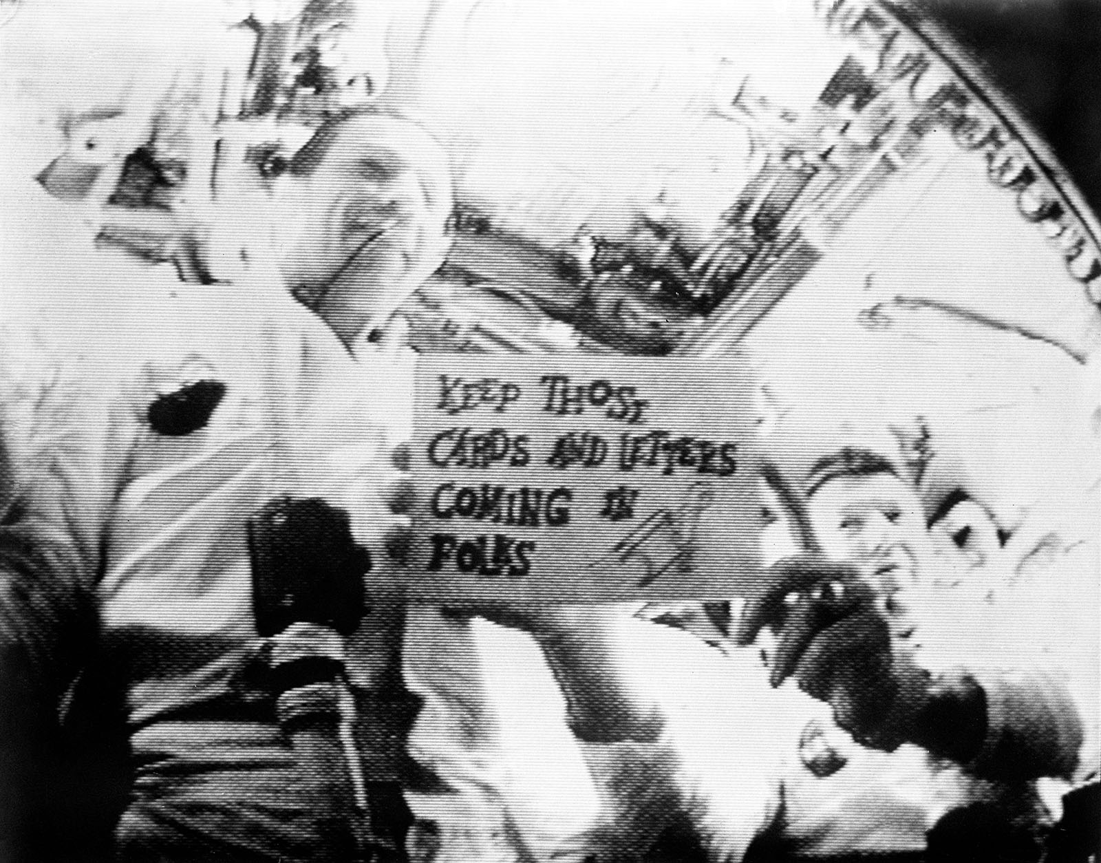 A photo of Apollo 7 Commander,Wally Schirra,holding a gag card