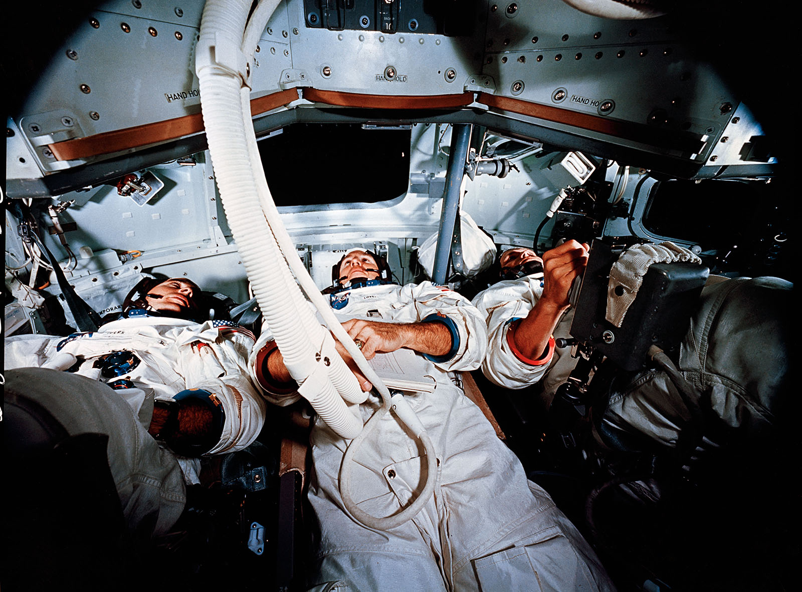 A photo of Apollo astronauts,Anders,Lovell, and Borman inside a simulator