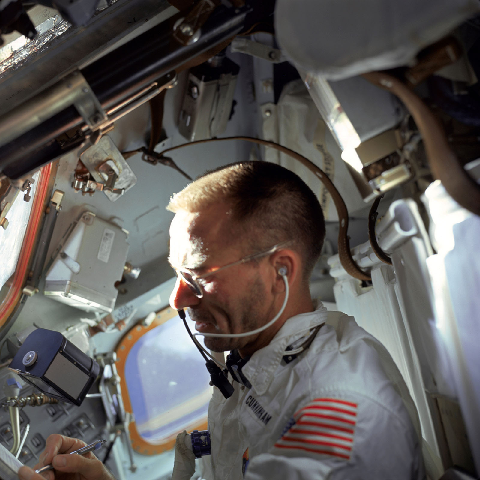 A photo of Cunningham, lunar module pilot on Apollo 7 making notes