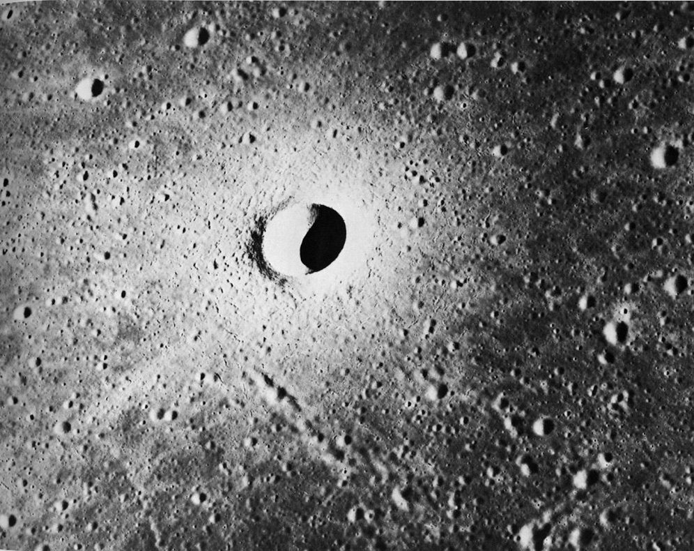 FIGURE 102. - The characteristics of an extremely youthful small crater are illustrated in this Apollo 15 panoramic camera photograph of the crater Linne as viewed from the south. 