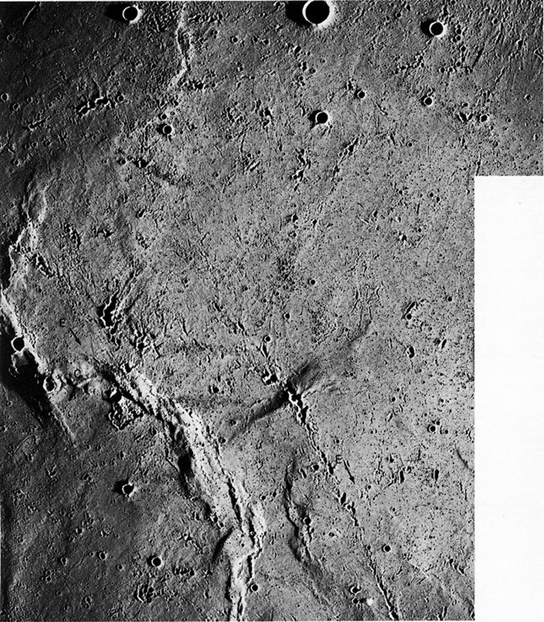 FIGURE 124. - This photo taken at low Sun angle emphasizes how common secondary impact craters are on the Moon. 