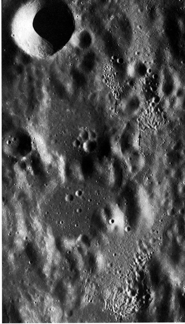 FIGURE 128. - These three clusters of secondary craters (see arrows) are on the east flank of the larger crater Ptolemaeus near the center of the Moon's near side.