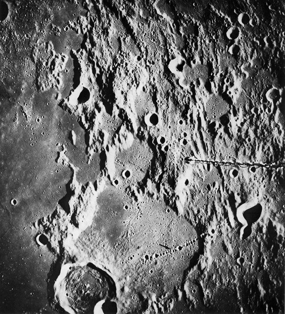 FIGURE 130. - The Davy crater chain (arrow) is one of the most spectacular chains of craters on the Moon.