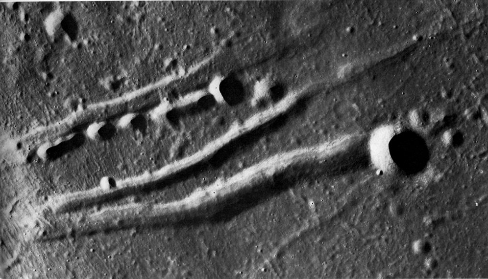 FIGURE 135. - This crater chain in southern Mare Serenitatis is clearly of internal origin because it is lined up parallel to several fault valleys or grabens.