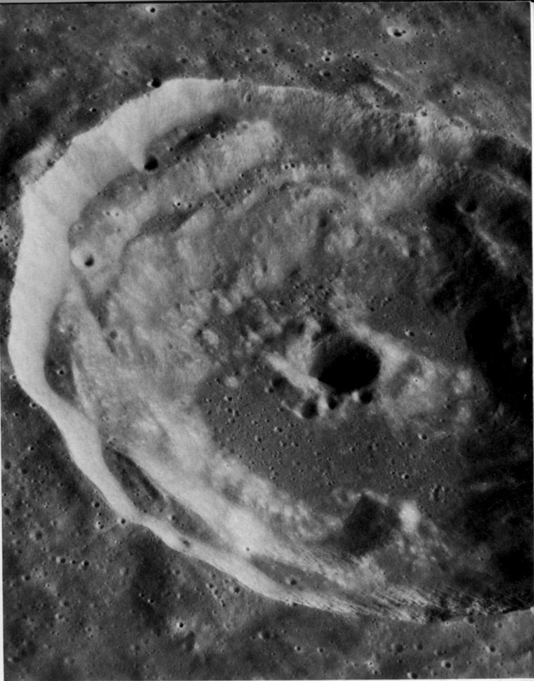 FIGURE 142. - This oblique view of the crater Timocharis in southeastern Mare Imbrium illustrates how the original diameter of a crater is enlarged by slumping of its walls.