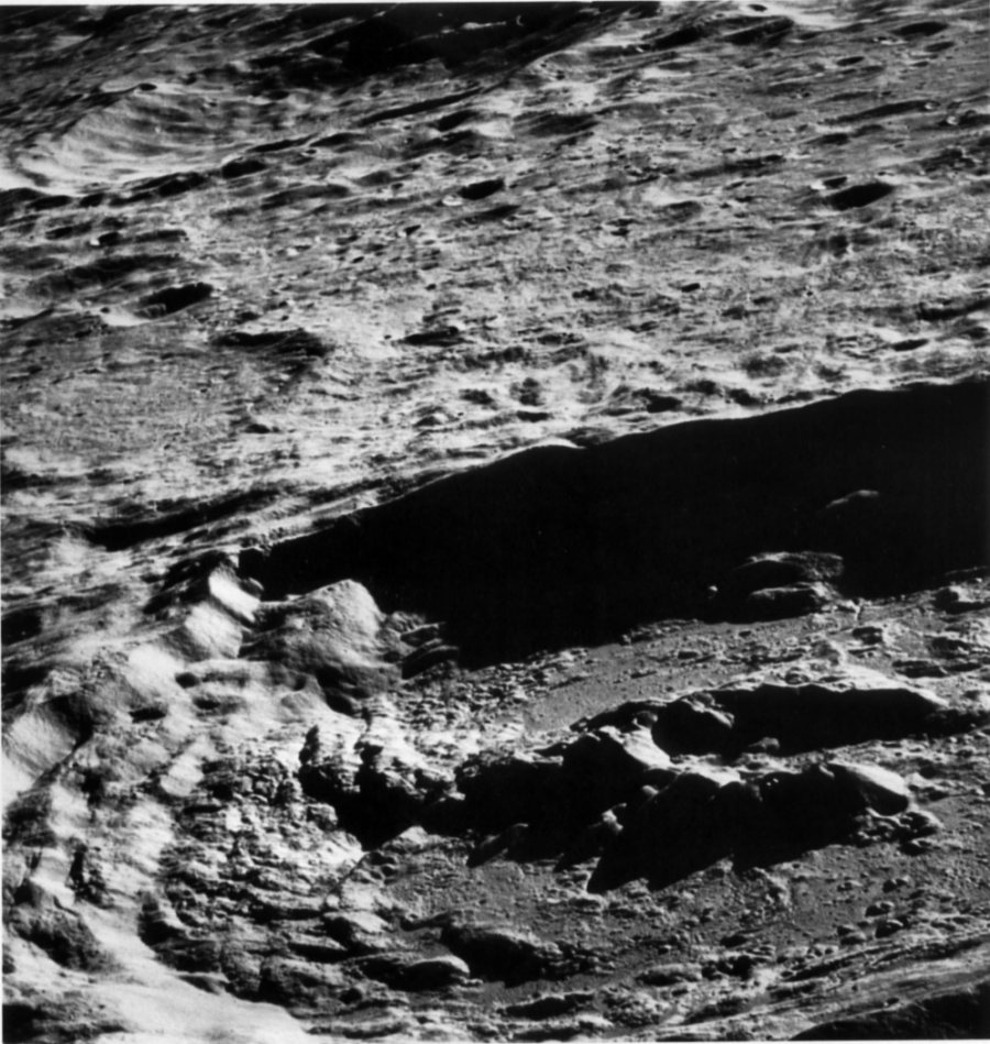 FIGURE 150. - The similarity in appearance of the southern part of the central peak and the slump terraces on the southern wall of the crater is emphasized in this oblique view of the crater King. 