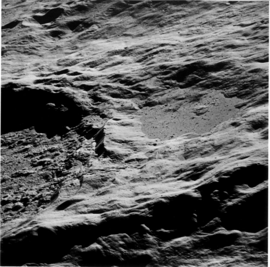 FIGURE 155. - The Apollo 16 astronauts captured this spectacular view of the large dark <<pool>> on the north flank of the crater King (left) as they approached from the east. 