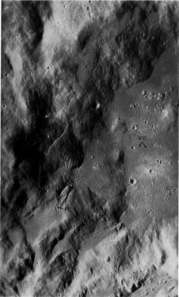 FIGURE 156. - Here the Apollo 16 panoramic camera views the same large pool of dark material. For orientation, the hill identified by an arrow is the <<island>> near the center of the pool in Figure 155.