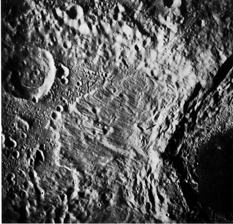 FIGURE 175. - This apronlike expanse of striated material on the northwest flank of Tsiolkovsky is interpreted as a giant landslide. 