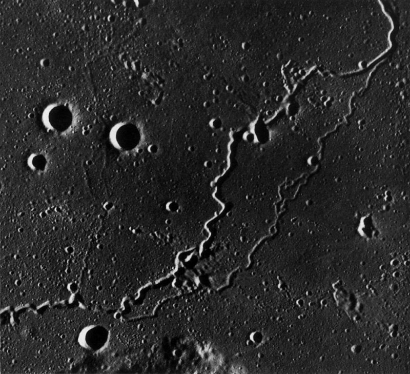 FIGURE 198. - The branching sinuous rille in this photograph is part of a continuous single rille extending more than 300 km across the mare in northeast Oceanus Procellarum.