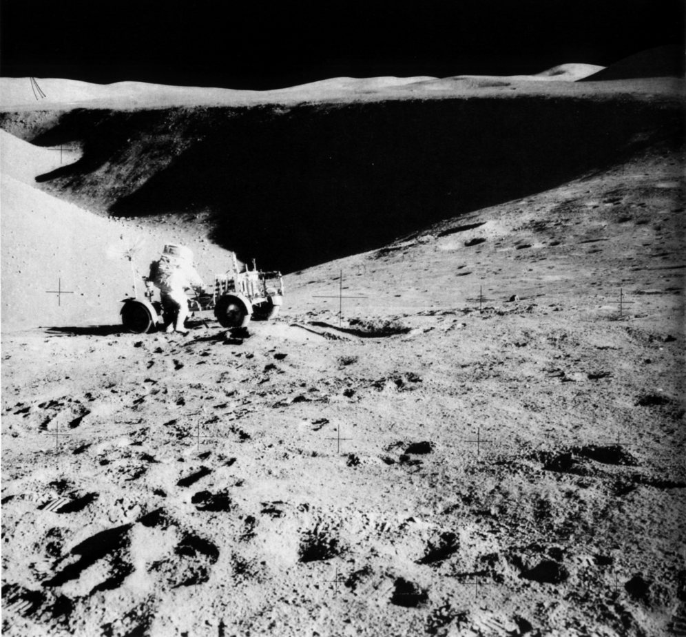 FIGURE 203. - Astronaut James Irwin and the Apollo 15 rover are perched here above the rim of Hadley Rille. 