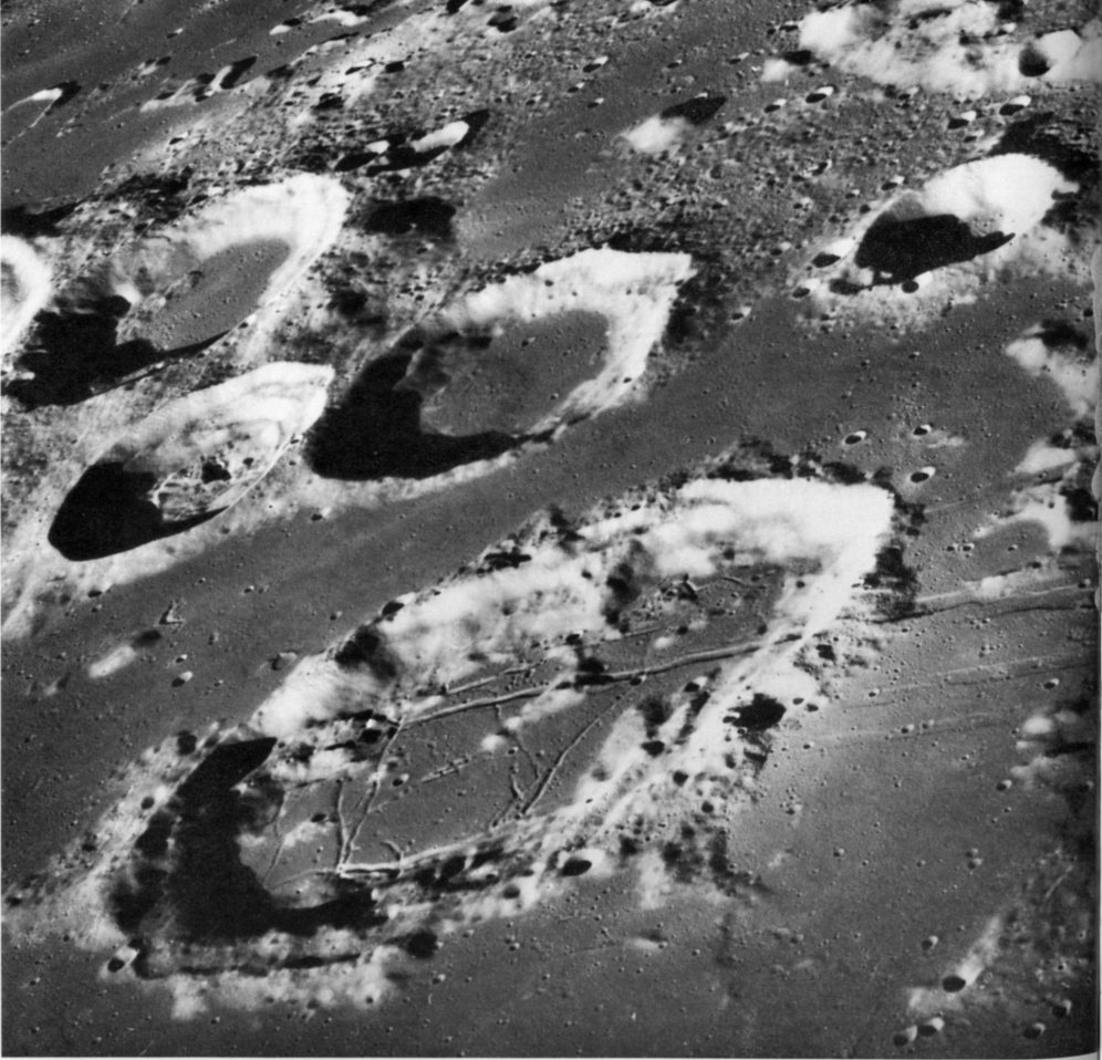 FIGURE 209. - This oblique view looks westward over the crater Goclenius (large crater in the foreground) at the western edge of Mare Fecunditatus.