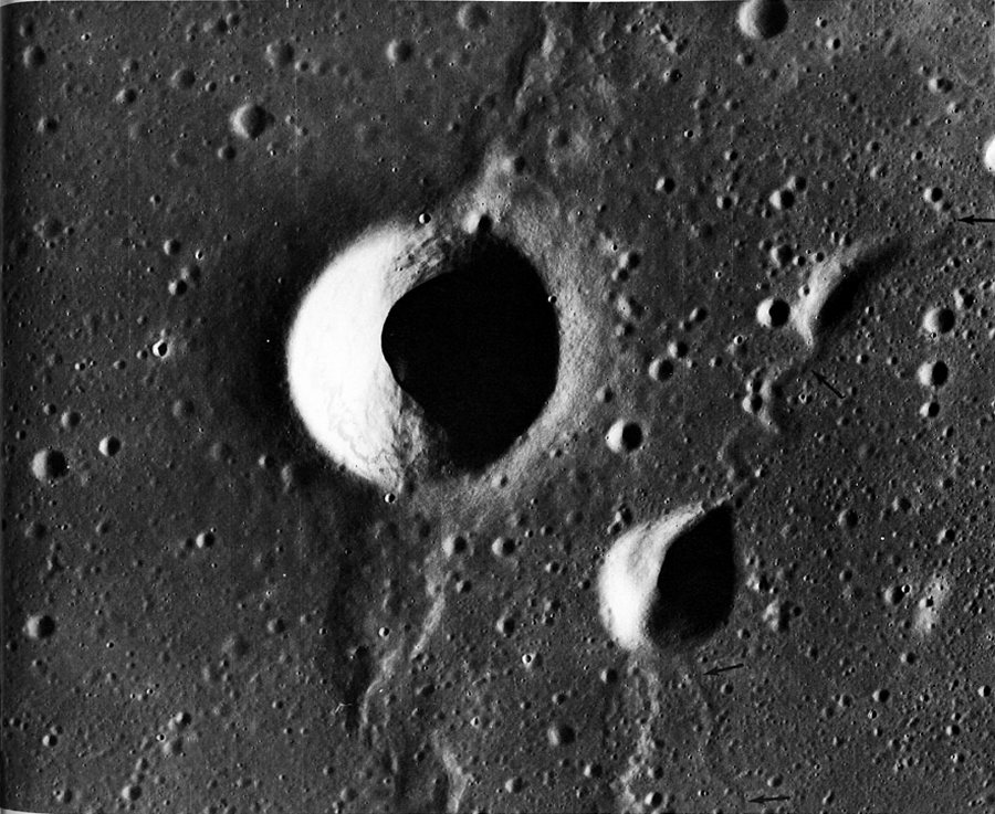 FIGURE 227. - The largest crater in this picture is Aratus D in western Mare Serenitatis. Its circular outline, high rim, and deep bowl-shaped interior are characteristic of many impact craters of comparable size and age. 