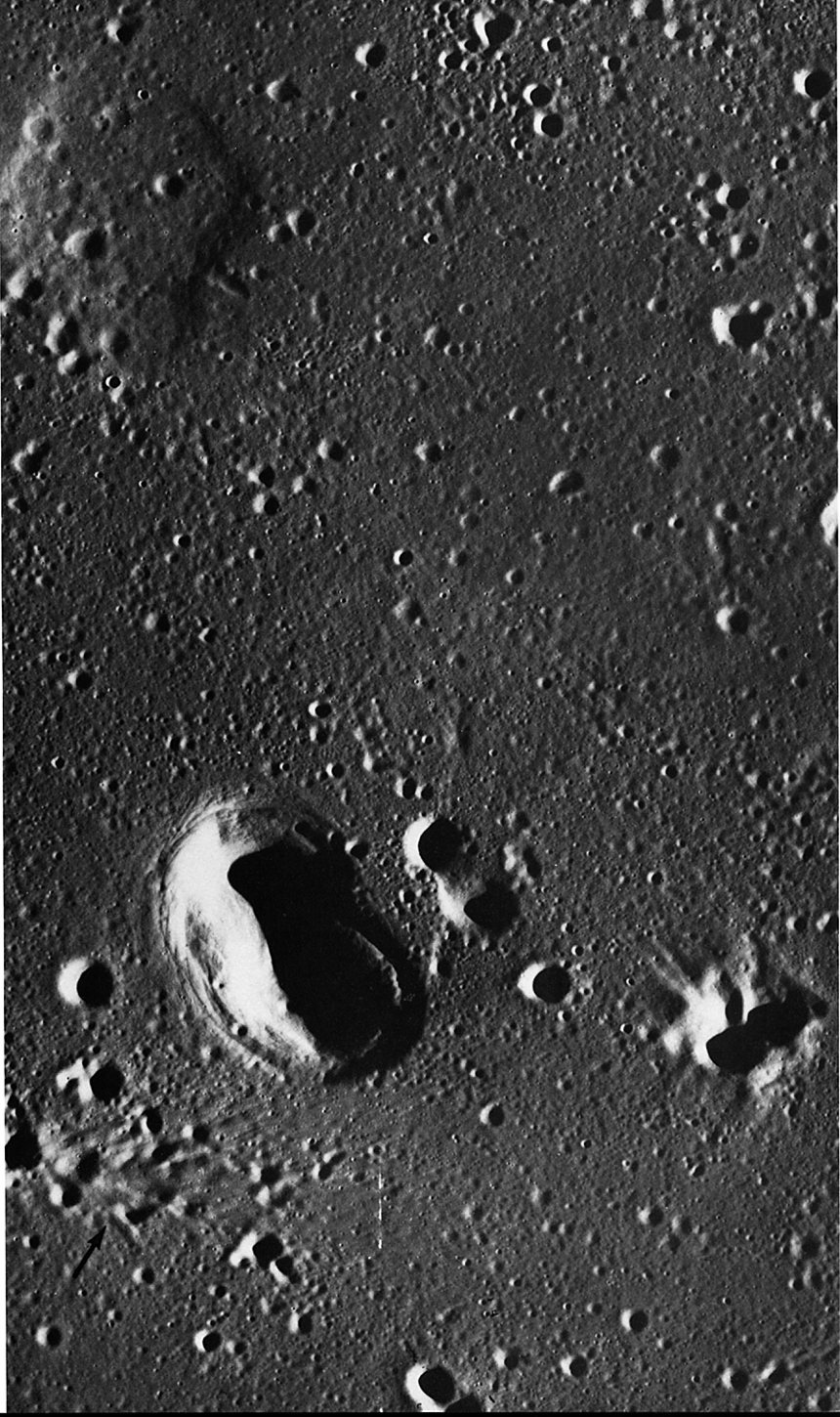 FIGURE 228. - The very young rimless crater near the center of this picture is located near the area where Oceanus Procellarum and Mare Imbrium join. 