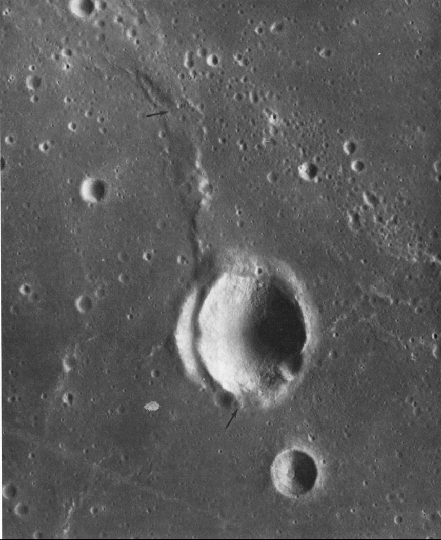 FIGURE 246. - This small unnamed crater in Mare Cognitum is unusual because it appears to be deformed by a fault that also bounds a mare ridge.