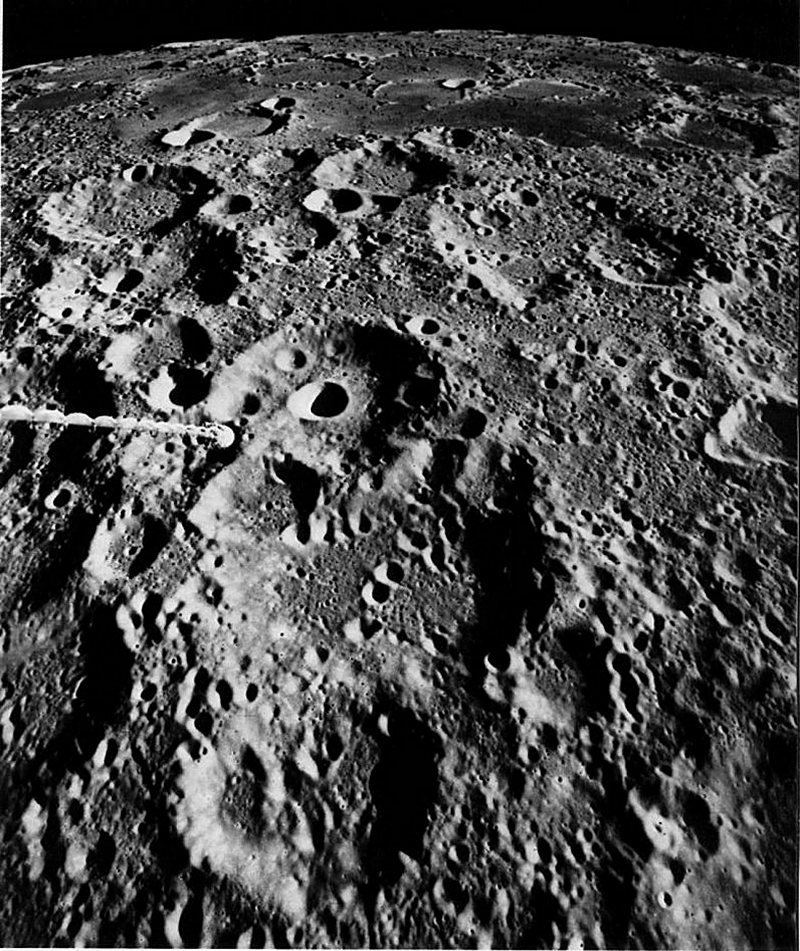 FIGURE 21. - This view, one of the most southerly photographed by the Apollo astronauts, straddles the boundary between near and far sides and shows terrain typical of both sides.