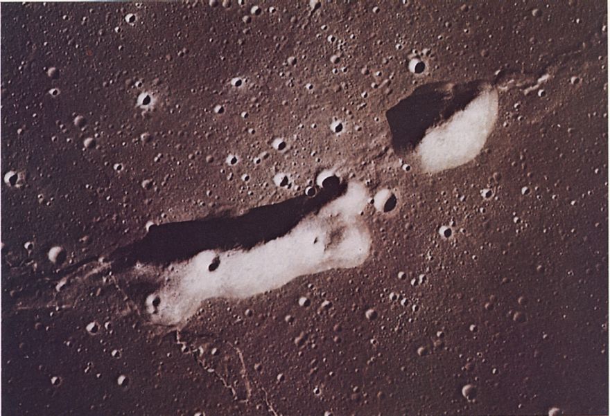 FIGURE 69. - This cluster of features in Mare Cognitum was photographed in color with a handheld camera and 250-mm lens. Its location on a mare ridge is shown in figure 91. 