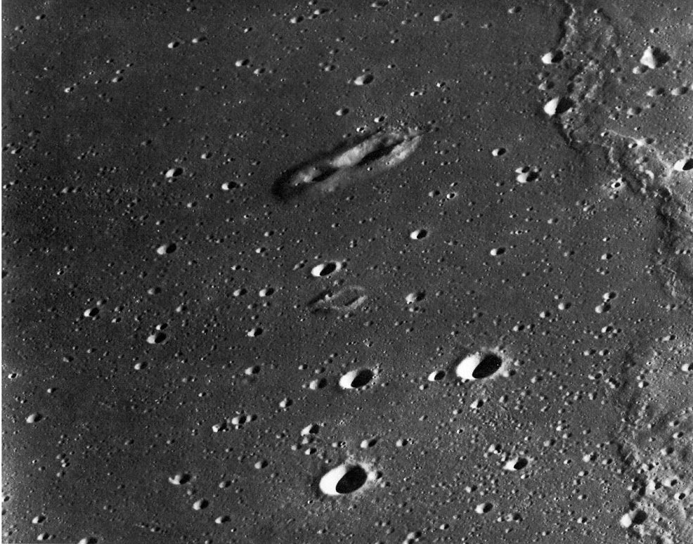 FIGURE 89. - A few volcanic craters lie in a field of impact craters in Oceanus Procellarum, northwest of the Aristarchus plateau.