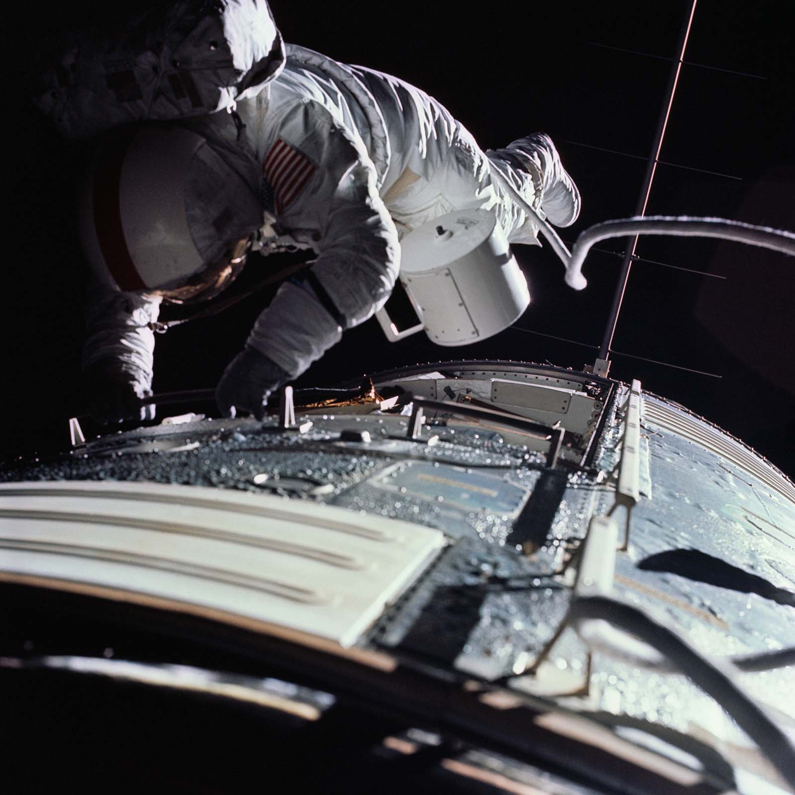 FIGURE 10. -  Astronaut Ron Evans retrieving film from the SIM bay cameras while the Apollo 17 spacecraft was returning to Earth. 