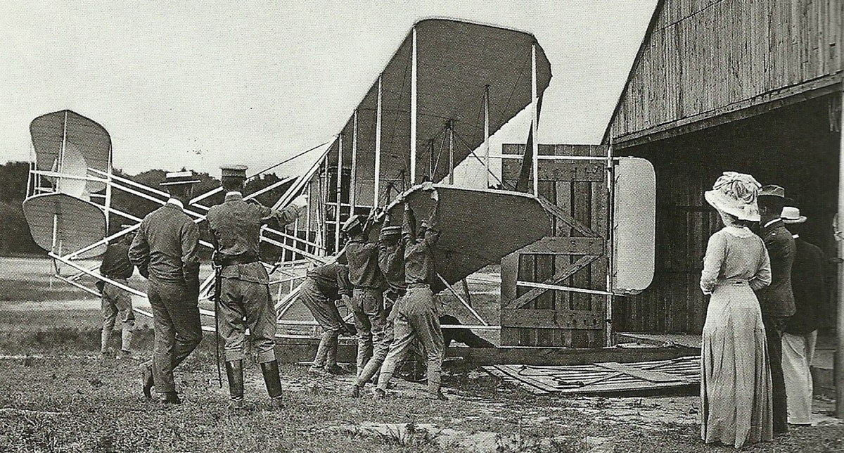 soldiers carrying Wright plane to runway