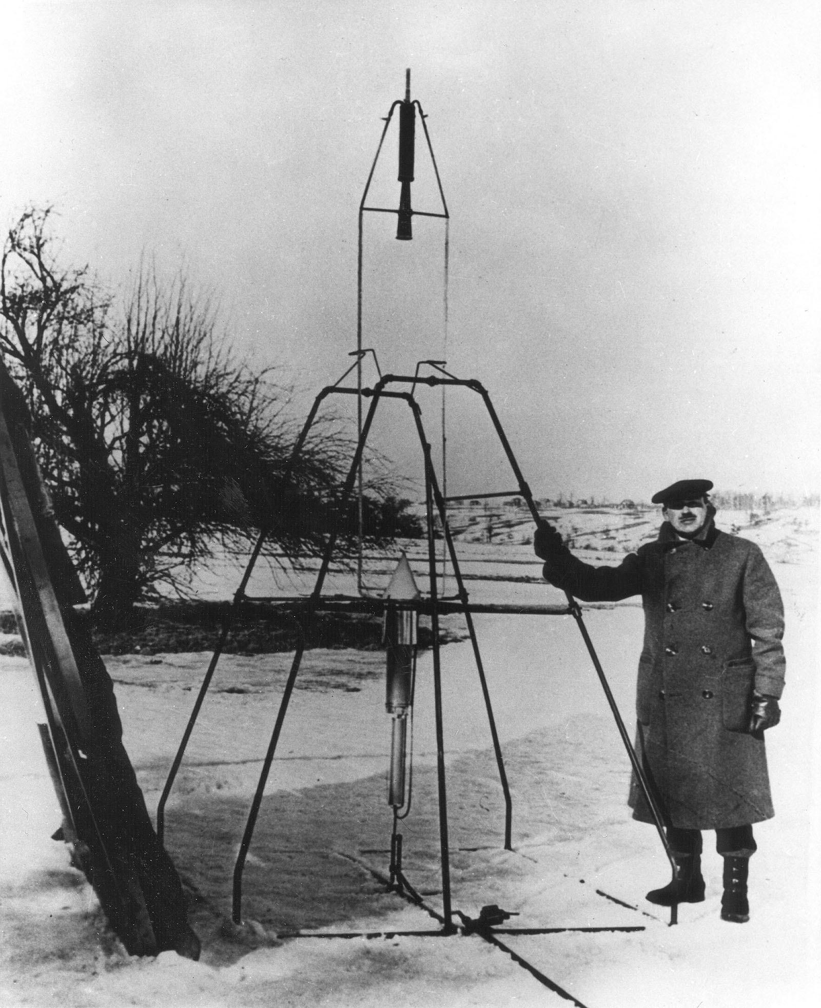 Scientist Robert Goddard pictured with early rocket